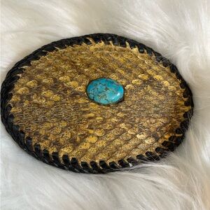 western-style belt buckle featuring a turquoise stone and rattlesnake skin inlay